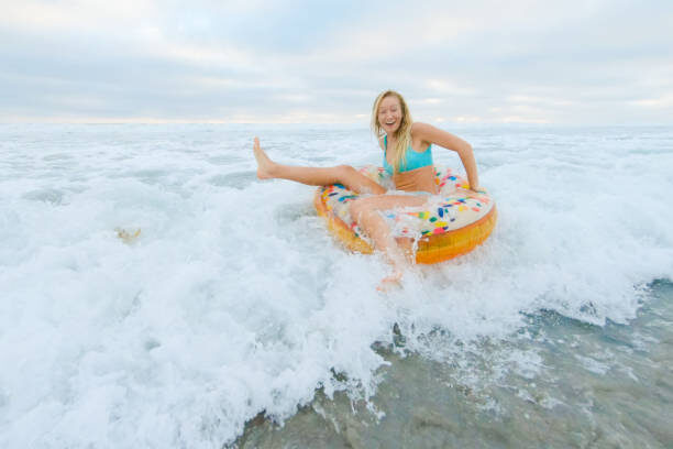 August in Encinitas: Summer in Full Swing - July 31, 2025 - Visit Encinitas CA August photo woman in water - Visit Encinitas CA - Discover the Coastal Charm of Encinitas